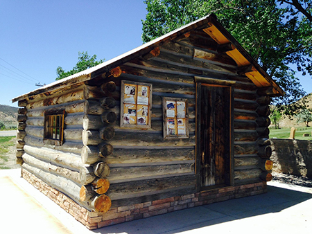 One of the original one room log cabins with a side window and wooden front entrance door